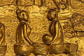 Luang Prabang, Laos - Wat Mai the gilded stucco engravings of the veranda. They narrate the Vessantara Jataka with scenes of everyday life.